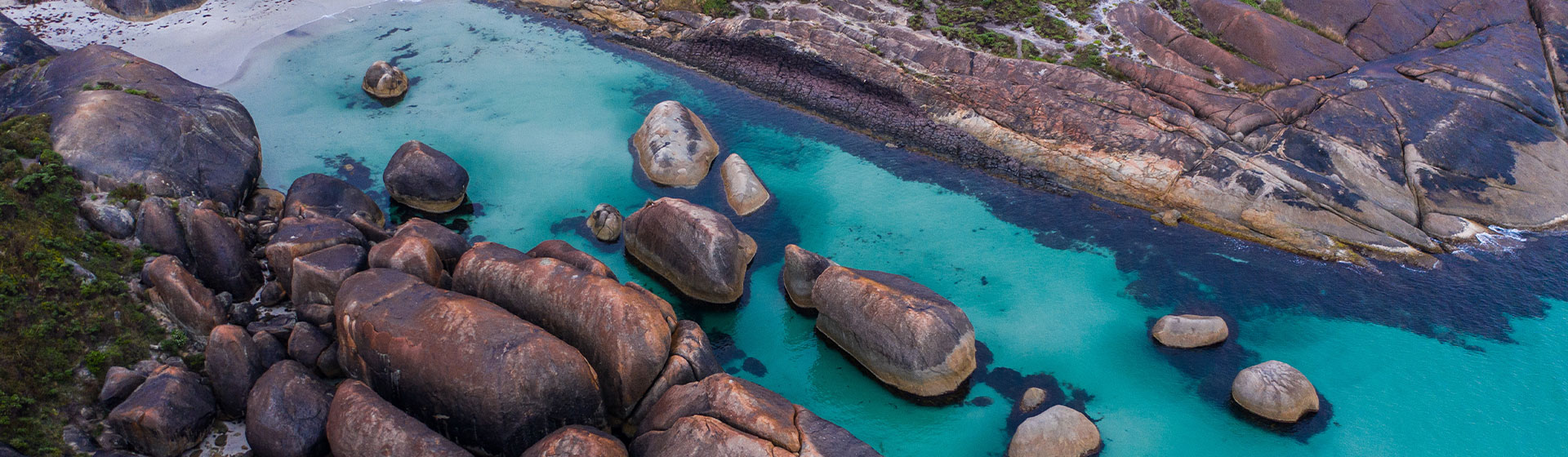 Aerial view of a beach with giant boulders that look like the shape of elephants, located near Denmark in Southwest Western Australia